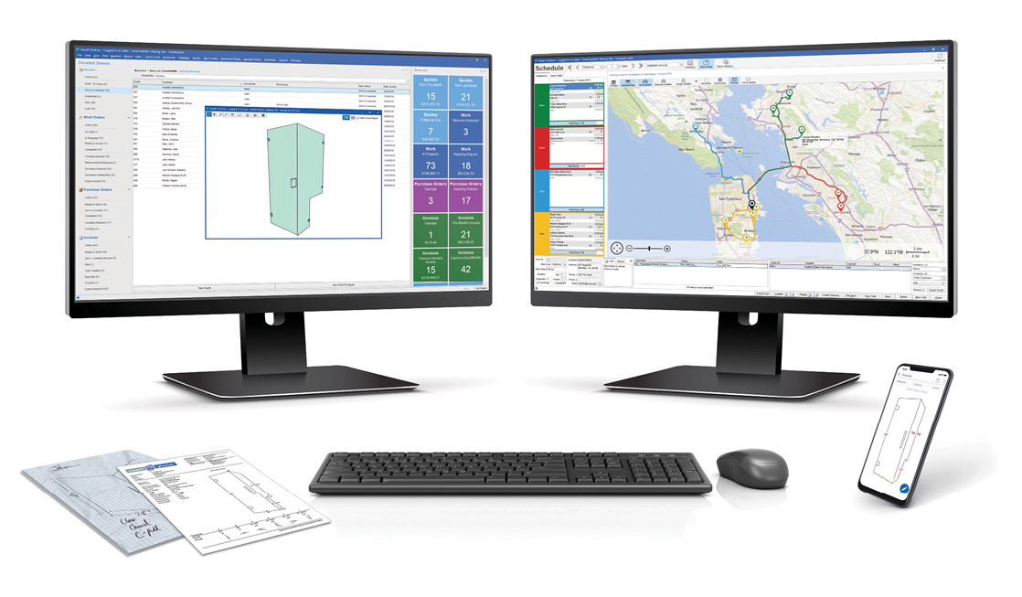 Multiple computer monitors displaying glass job management software