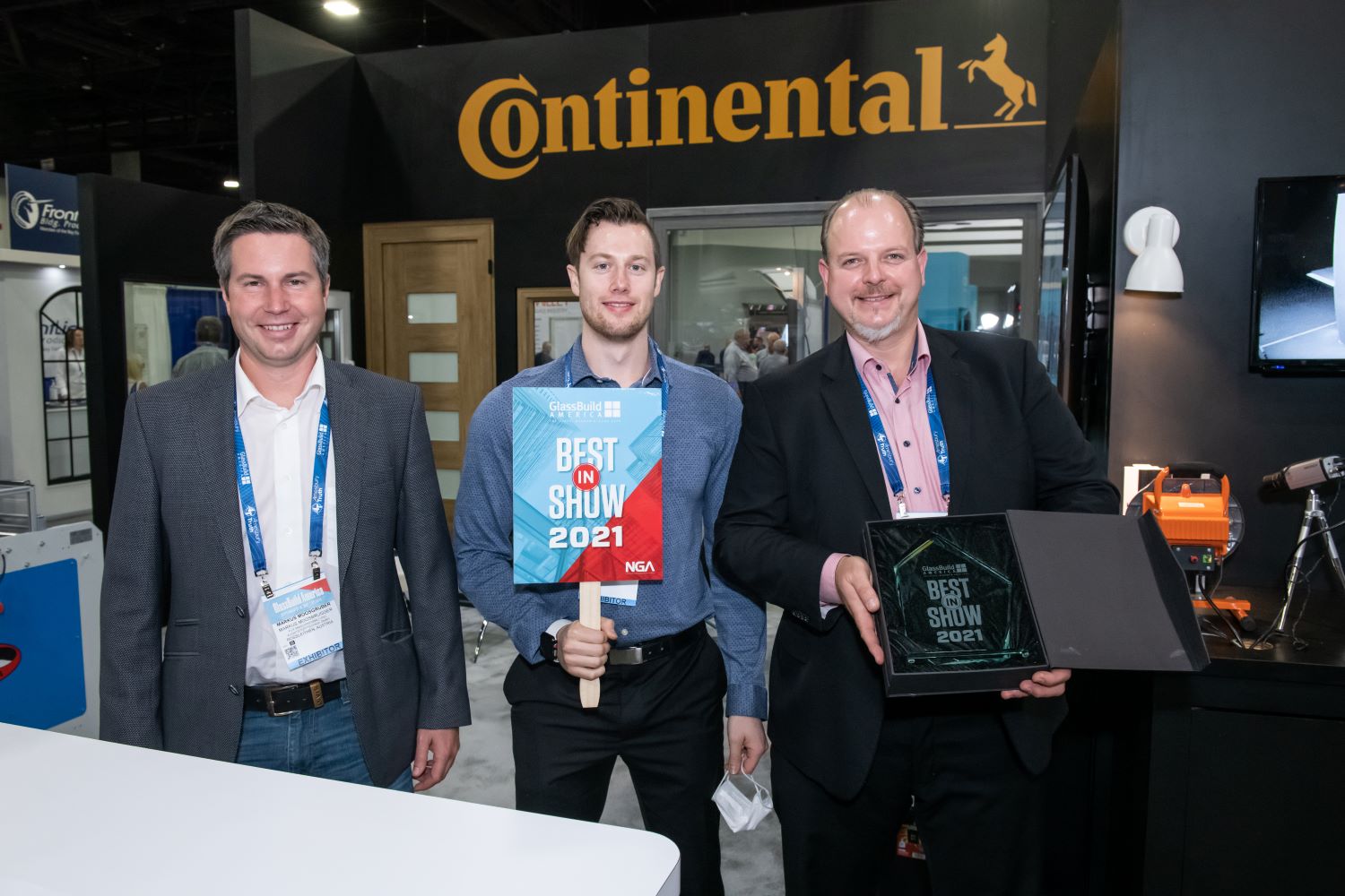 Three happy members of Continental team hold GlassBuild Best in Show Award