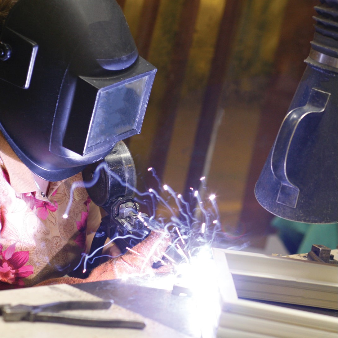 fenestration worker with mask on manufacturing line