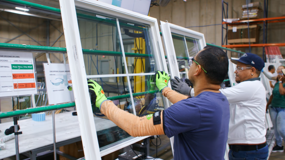 workers handling window units