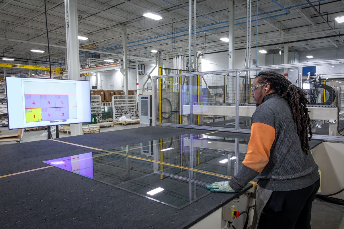 worker at glass cutting table