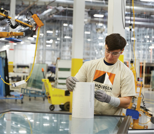 man working in window manufacturing facility