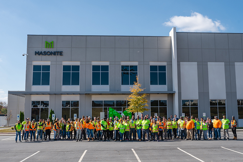 Masonite staff stand in front of the new facility