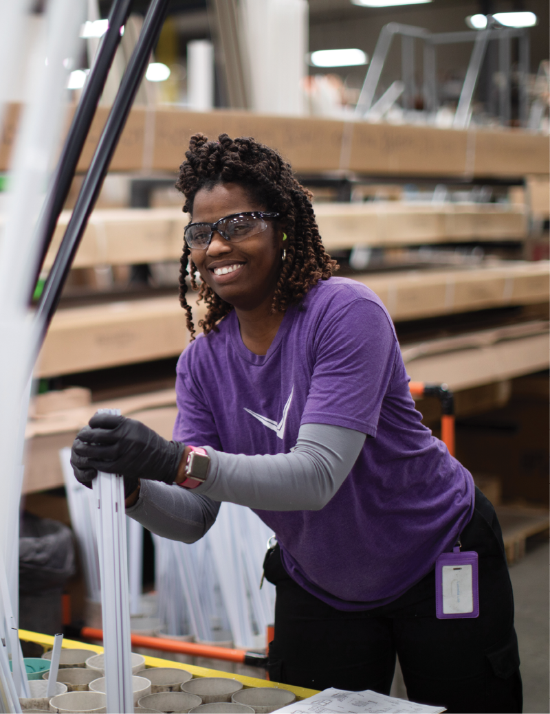 woman working on window manufacturing line