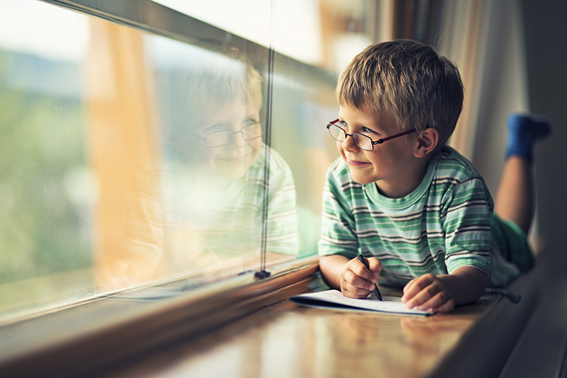 Child looks out window